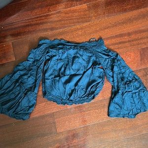 Needs to be ironed. But size Xs runs a little loose off the shoulders cropped